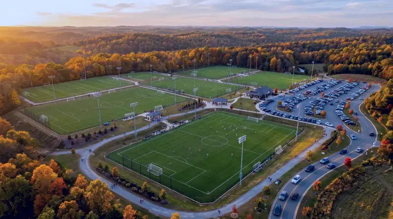 Aerial drone view of a youth soccer complex at golden hour