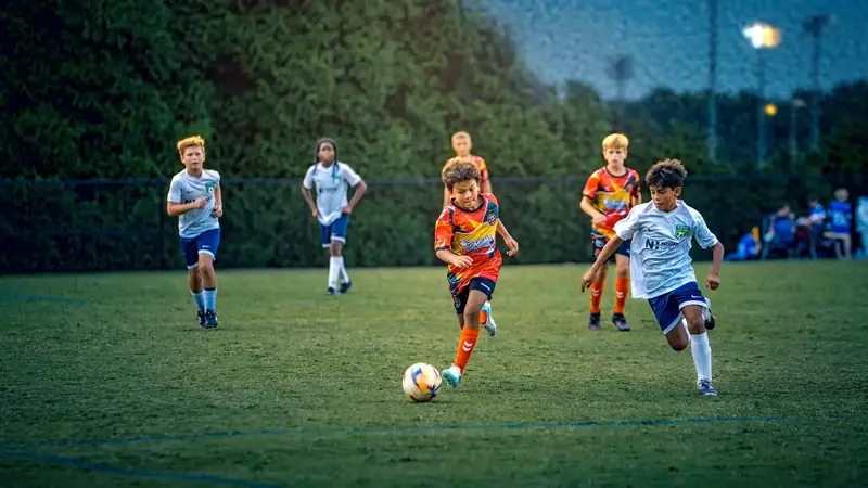 A U10 goalkeeper diving for a save in a 7v7 match